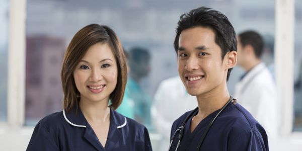 Nurses in dark blue uniform looking at the camera