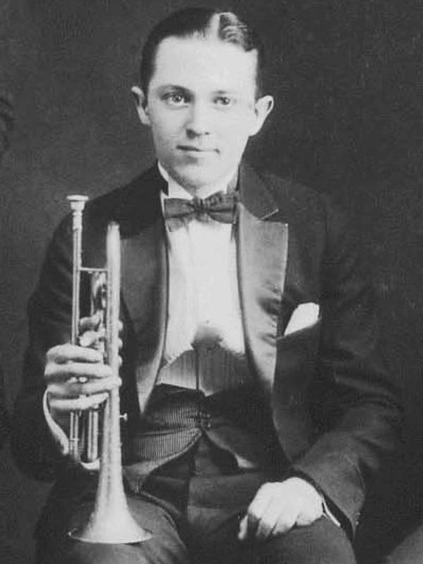 Bix Beiderbecke sitting with his cornet