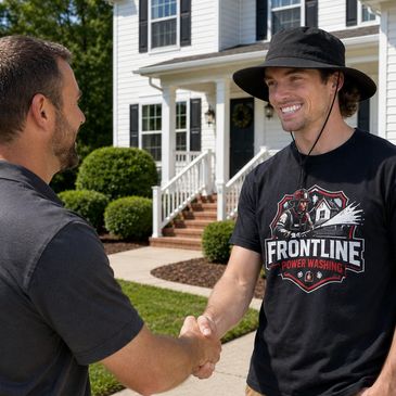 Two men shaking hands outside a house, one wearing a Frontline Power Washing shirt.