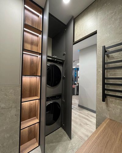 Modern laundry space with stacked washer and dryer enclosed in a sleek cabinet.