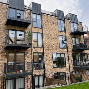 Modern brick apartment building with balconies.