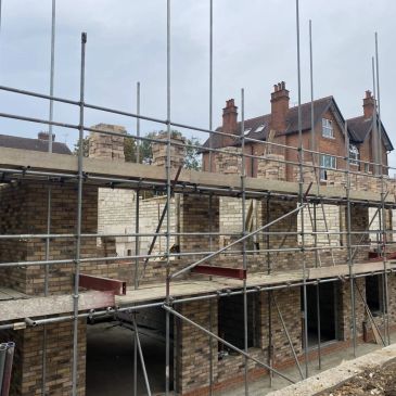 Building under construction with scaffolding around.