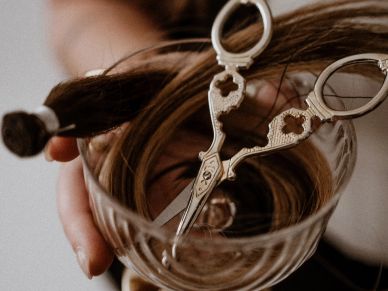 Hair wrapped around scissors in hand.