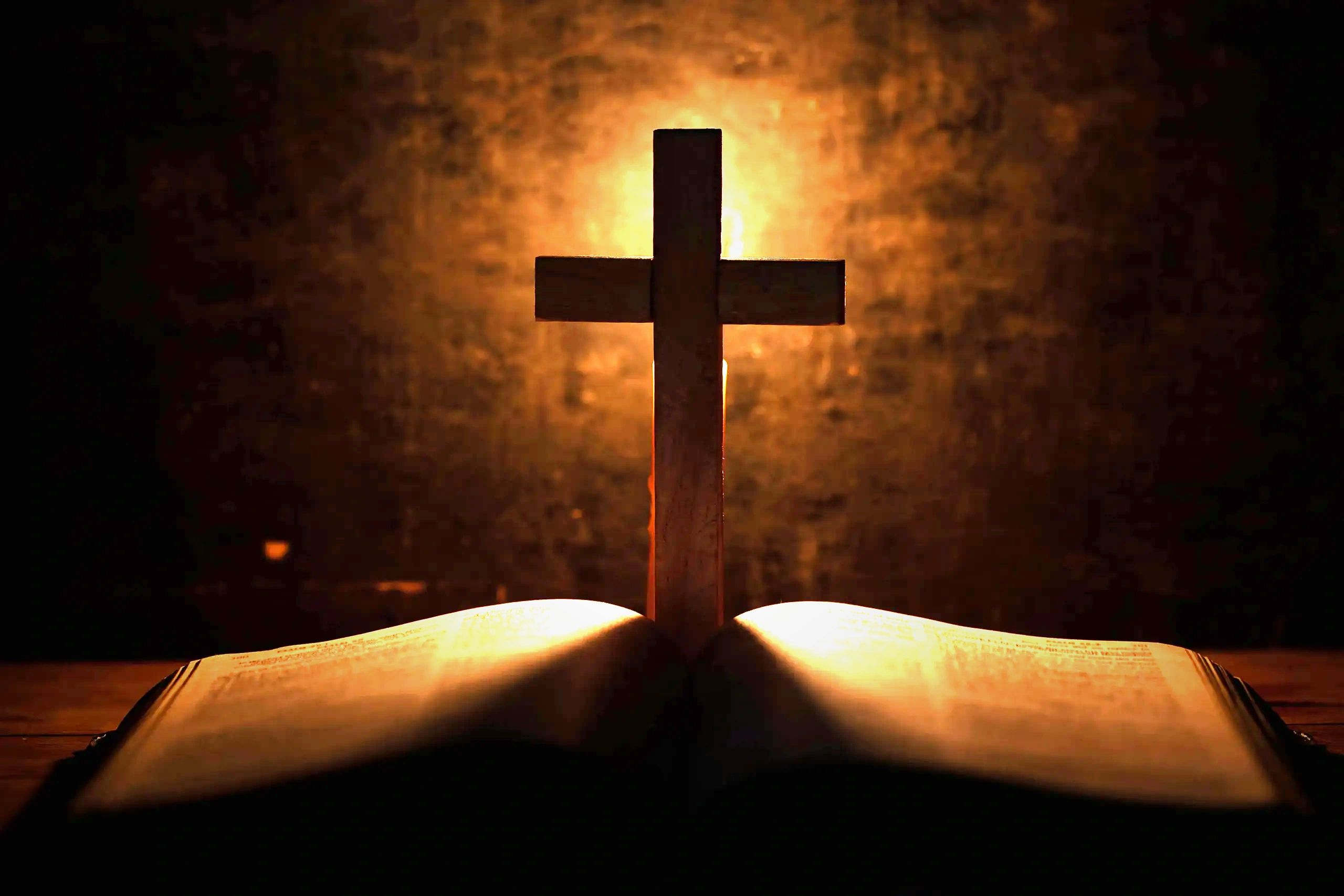 A Holy Cross placed over a bible.
