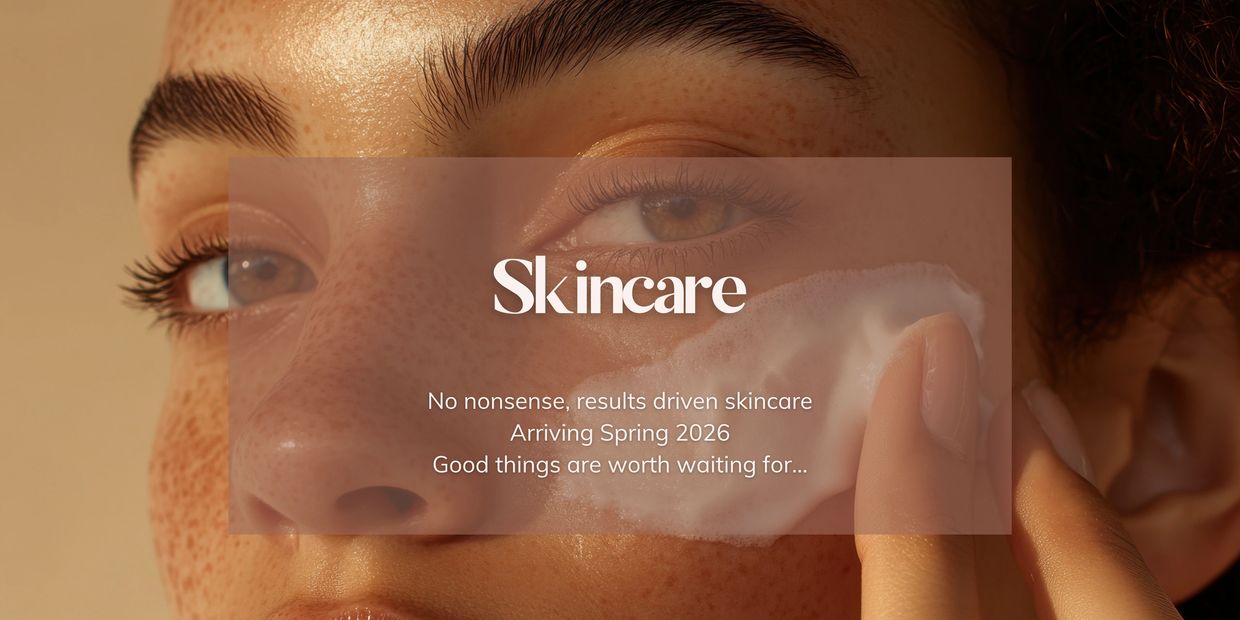 Someone with freckles applying a foamy treatment to their face.