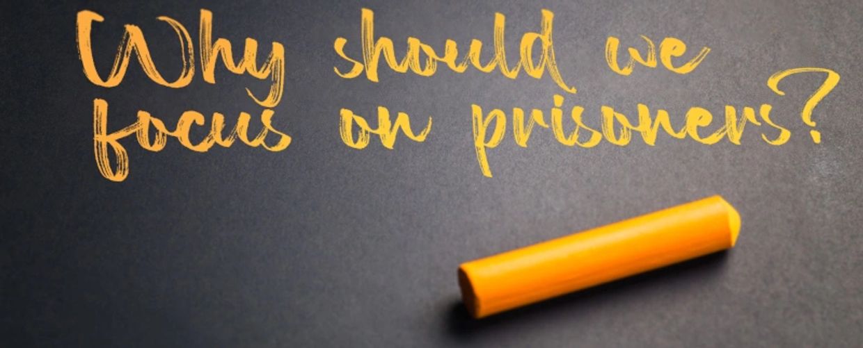 Black chalkboard with yellow text that reads: "Why should we focus on prisoners?"