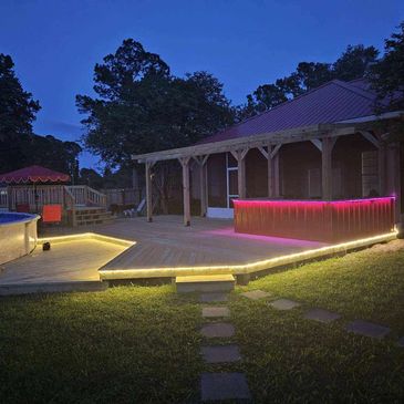 Lighted deck with roof and kitchen.