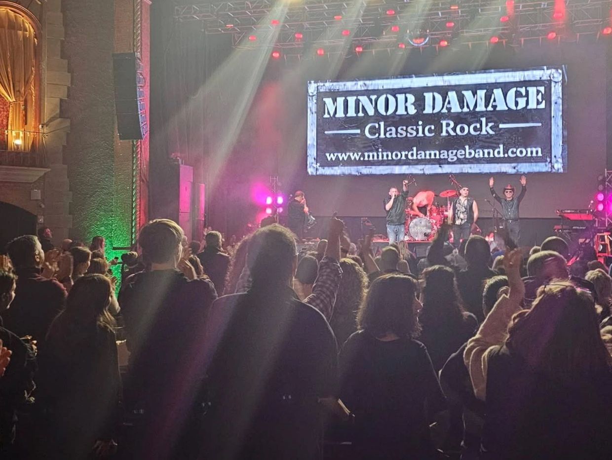 Crowd enjoying a live classic rock concert by Minor Damage.