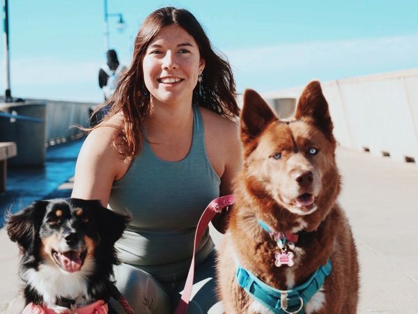 Amber poses with her two dogs, Athena and Aurora. 