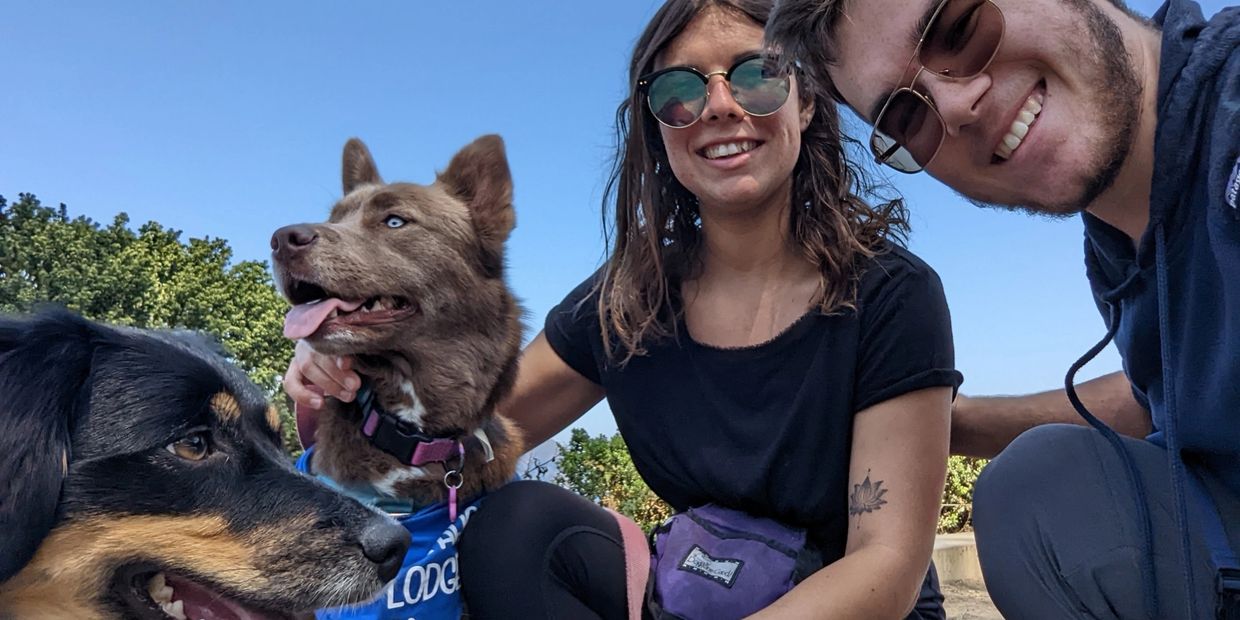 Co-owners Amber and Bryce pose with their two dogs, Athena and Aurora. 