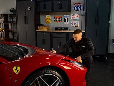 A man from elite valeting Nottingham detailing a Ferrari 