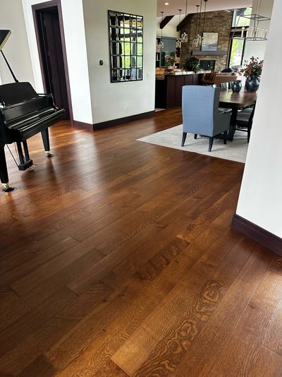 Elegant living space with polished wooden floors and a grand piano.