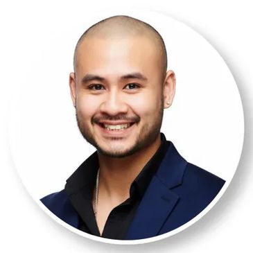 Smiling bald man in a blue suit.