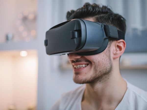 Young man enjoying virtual reality experience with VR headset.