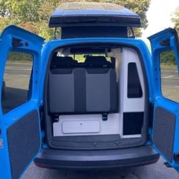 rear of blue vw caddy camper