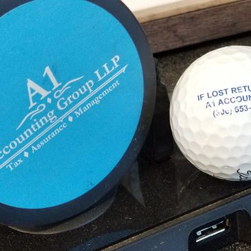 Golf ball and puck with logo.