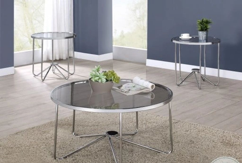 a round coffee table with 2 endtables.