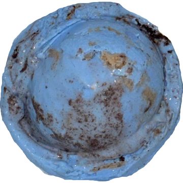 A worn, blue, dome-shaped metal object with rust spots.