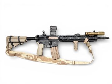 Tactical rifle with attachments and desert camouflage strap.