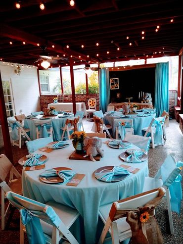 Elegant event setup with turquoise decorations and rustic charm.