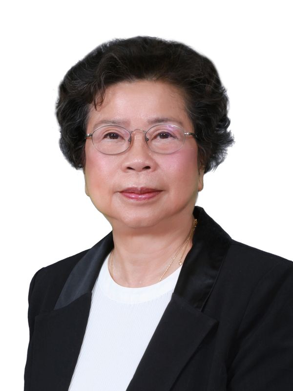 Portrait of an elderly woman wearing glasses and a black blazer.