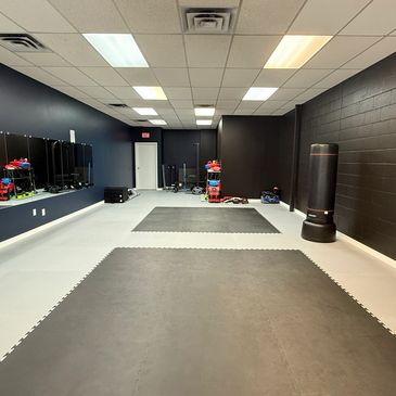 GoBeyond Martials training room with weights and martial arts equipment