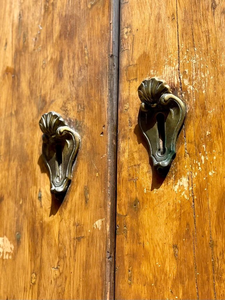 Door handles on wooden door.