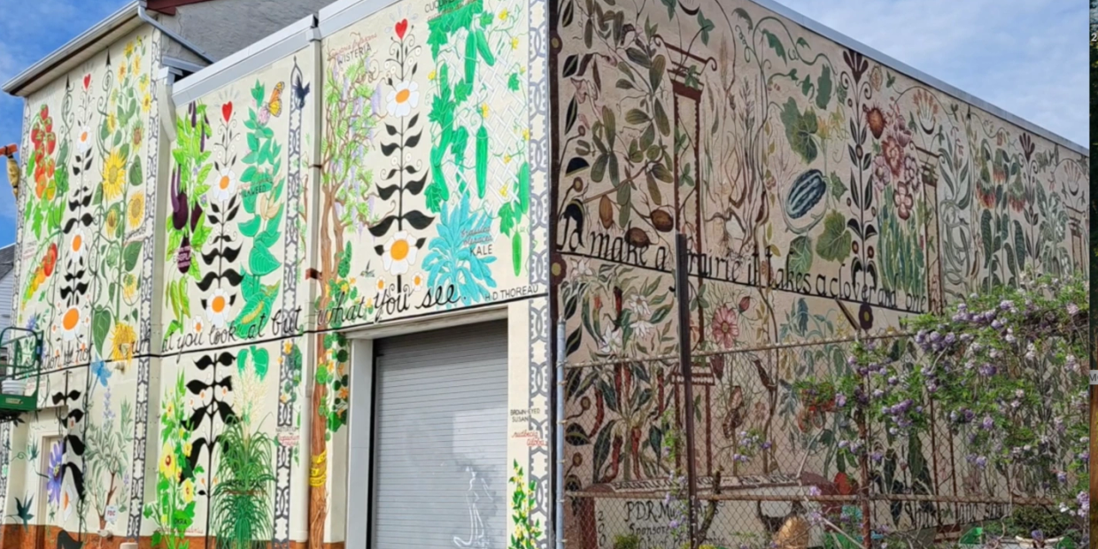 Colorful botanical mural on building walls with various plants and flowers.