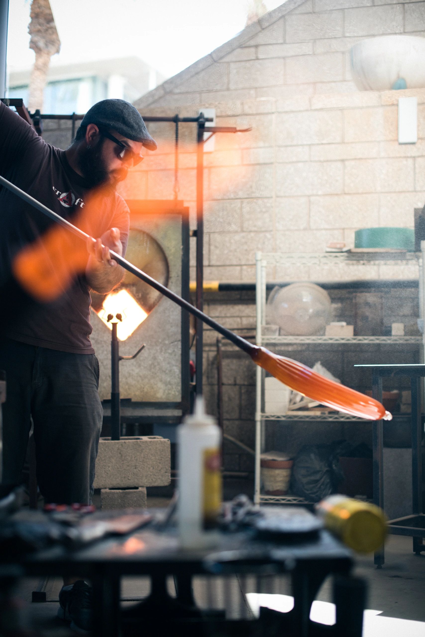 Phoenix Glass Center instructors working glass with a student