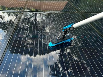 Water fed brush cleaning roof mounted solar panels.