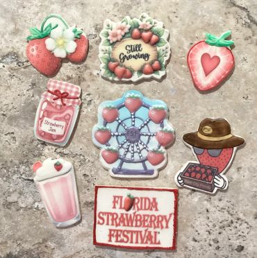 Cute strawberry-themed pins and patches with festival motifs.