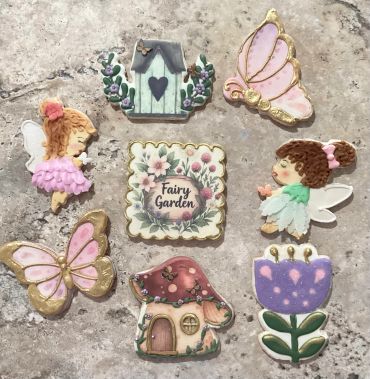 Decorative fairy garden themed cookies with fairies, butterflies, and flowers.