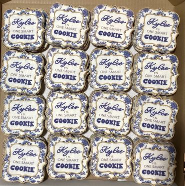 Decorative tins labeled 'Kylee is one smart cookie' arranged in a grid.