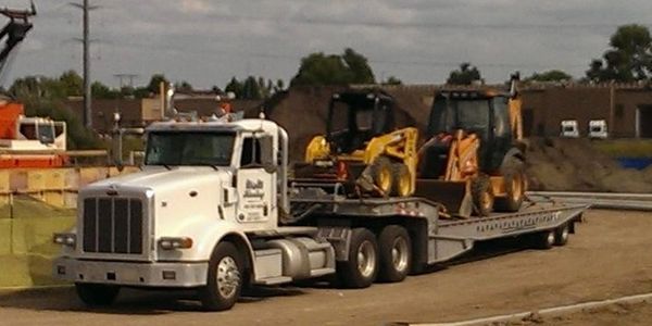 landoll hauling skid and backhoe