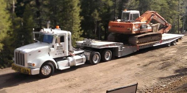 landoll hauling an excavator