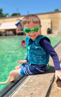 Boy sitting by pool