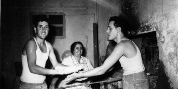 Renato(left) his, mother and his brother Toni making bread in the family bakery oven