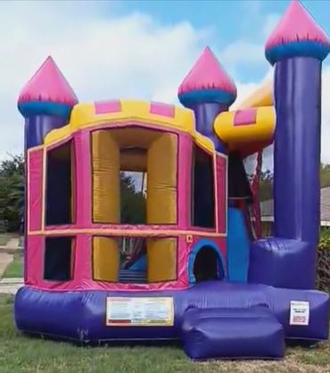 "Pink, yellow, and purple combo bounce house.a jumping area, slide, ladder, and basketball hoop."