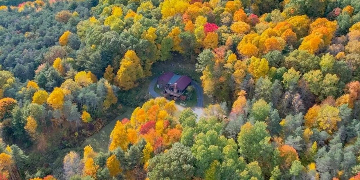 A retreat center surrounded by colorful trees in fall