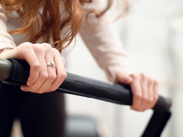 hands on a reformer footbar