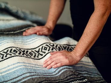 hands on a yoga blanket performing Reiki