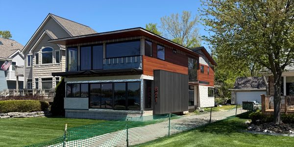 Angled view capturing the modern addition’s interaction with natural surroundings—featuring layered.