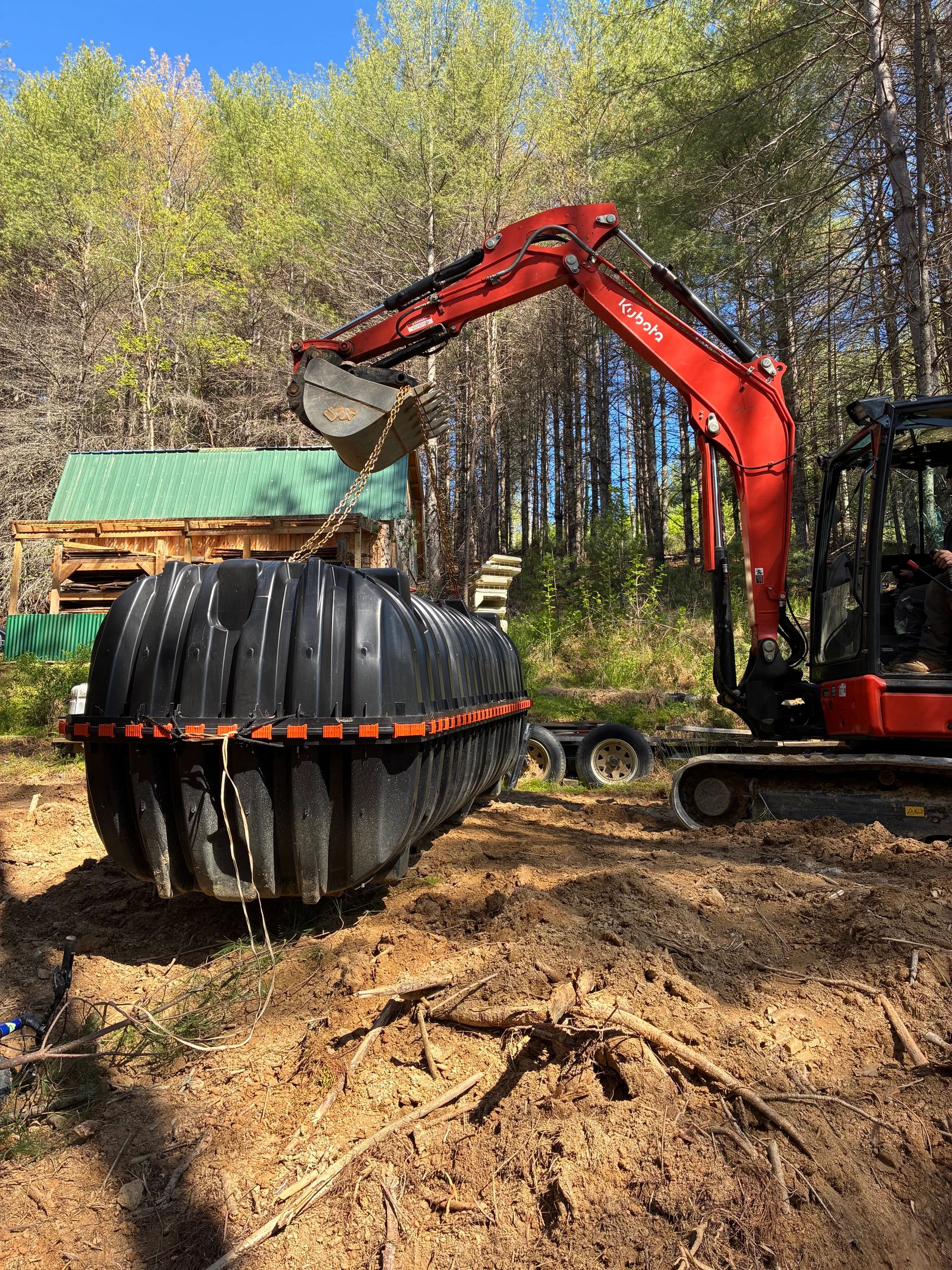 Installing a 1500 gallon septic tank for a 5 BR drainfield. 