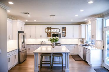 Bright modern kitchen with white cabinets and island.
