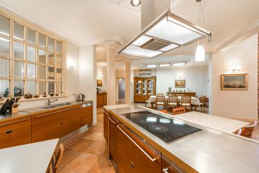 Modern kitchen with wooden cabinets and a spacious dining area.