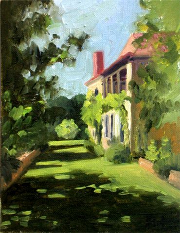 Farmhouse in France with lawn in front and lots of greenery