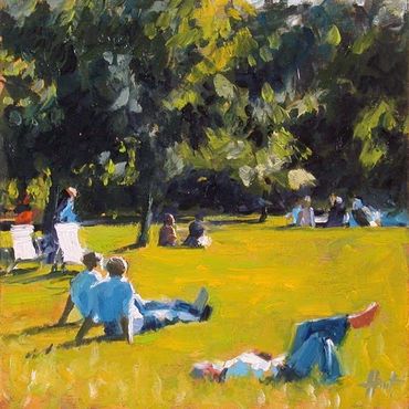 People lying on lawn, enjoying the sun in a park