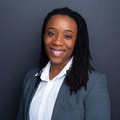 Professional woman smiling in business attire.