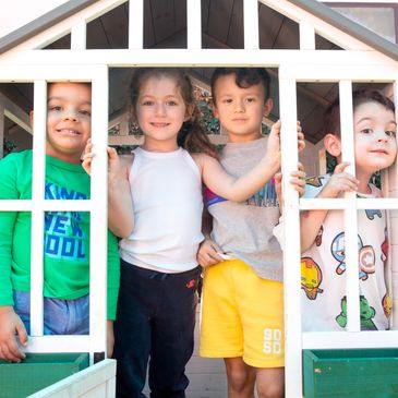 Preschoolers playing outside in our playground at Fun Two Three Preschool