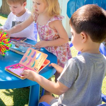 Child reading a book at our Russian Daycare in Encino CA